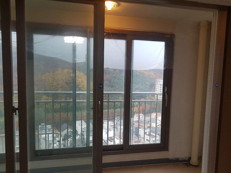 투명 필름이 붙은 창호와 정돈된 벽면의 접합부