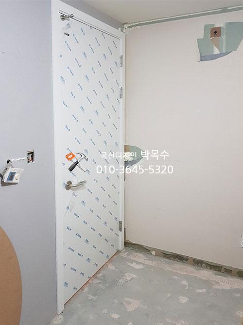 파란색 패턴 도어와 흰색 페인트 벽면