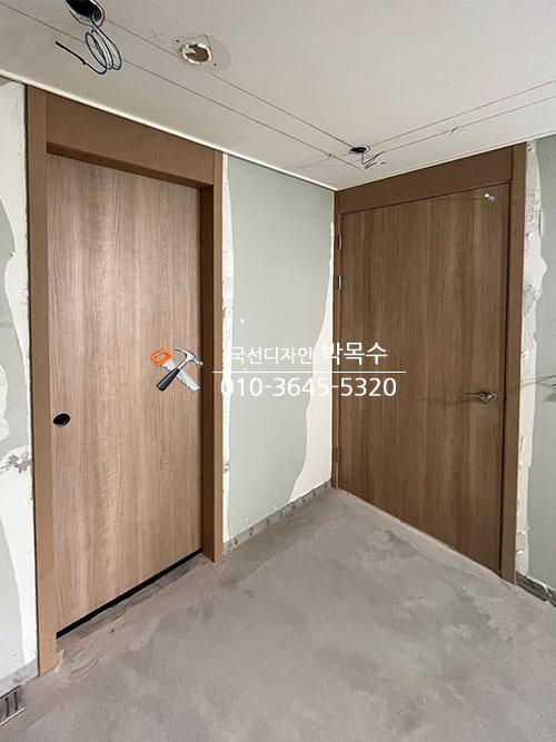 목재 도어 두 개가 설치된 복도 전경