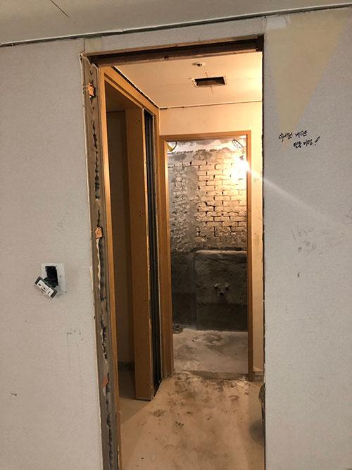 흰색 마감 처리가 진행 중인 복도 벽면
