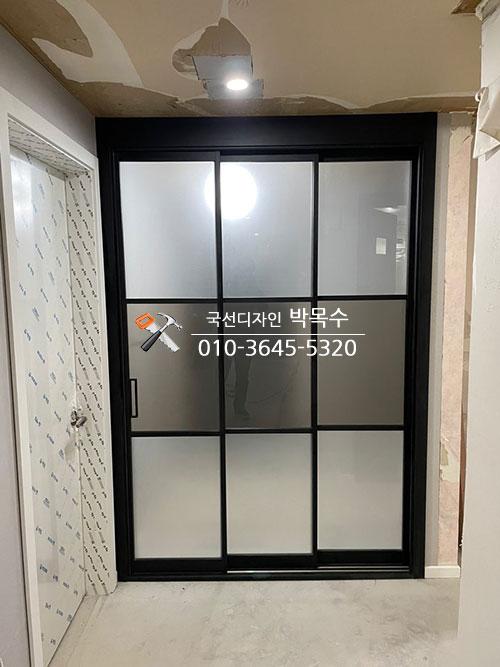 검은색 프레임의 슬라이딩 도어가 설치된 모습
