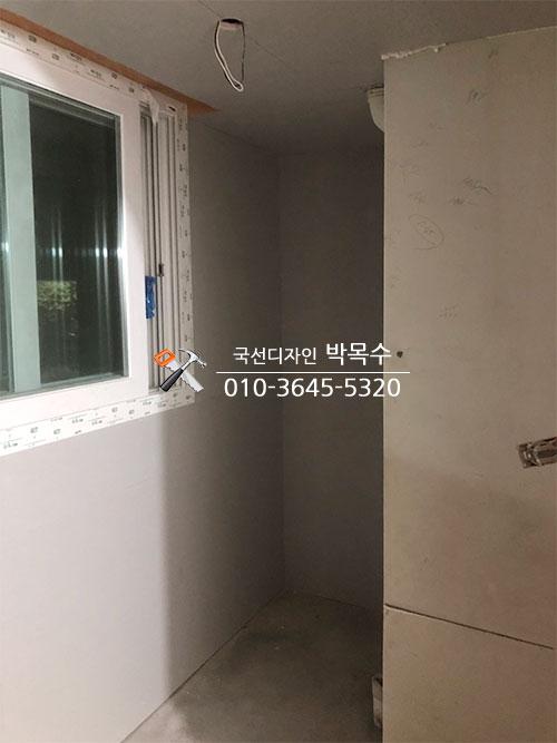 전선이 노출된 천장과 화이트 톤 마감재가 적용된 벽면