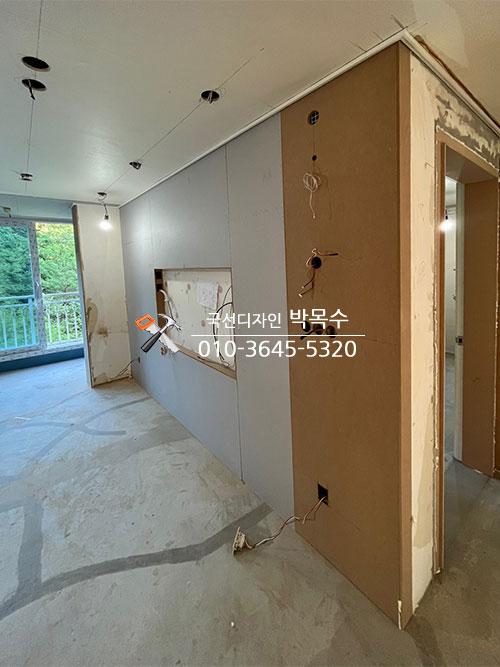 전선 노출과 타일 작업이 진행 중인 복도