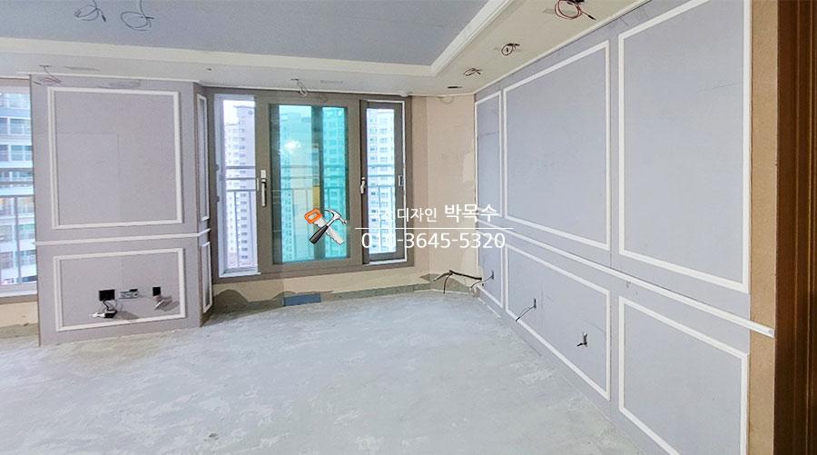 흰색 테두리의 회색 패널이 설치된 창가 벽면