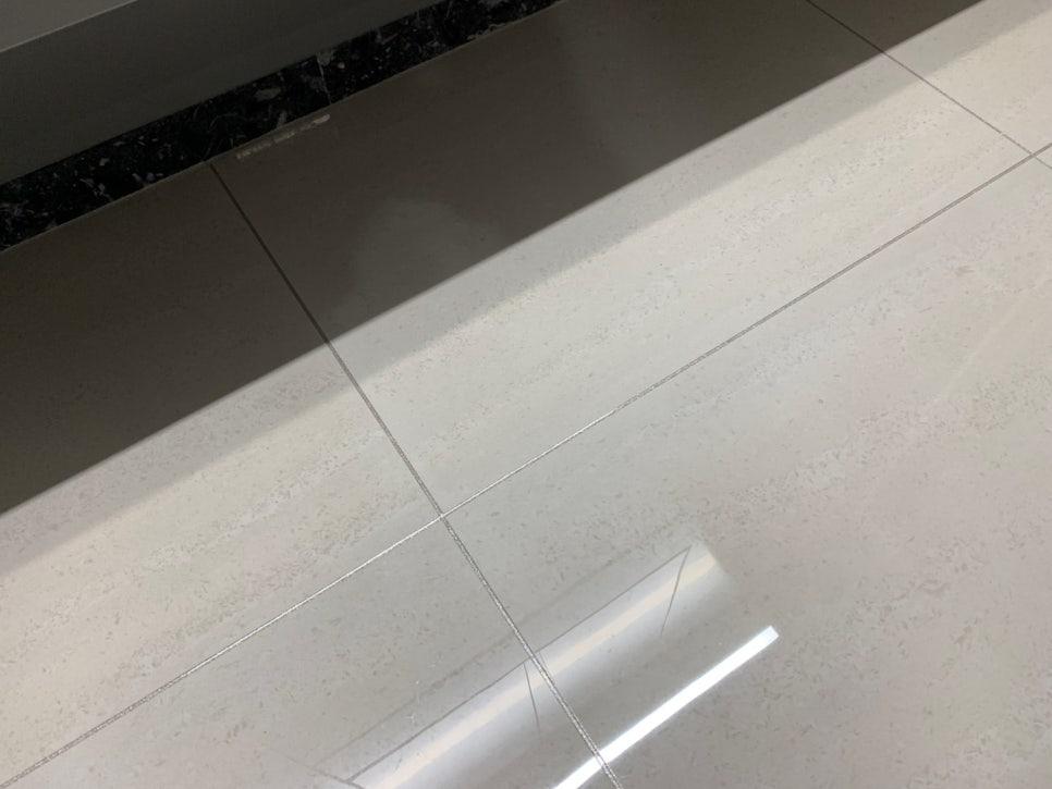 흰색 타일 바닥과 검은색 마감 벽면의 일부