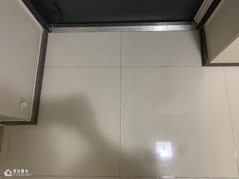검은 벽면과 대비되는 화이트 톤 바닥 라인