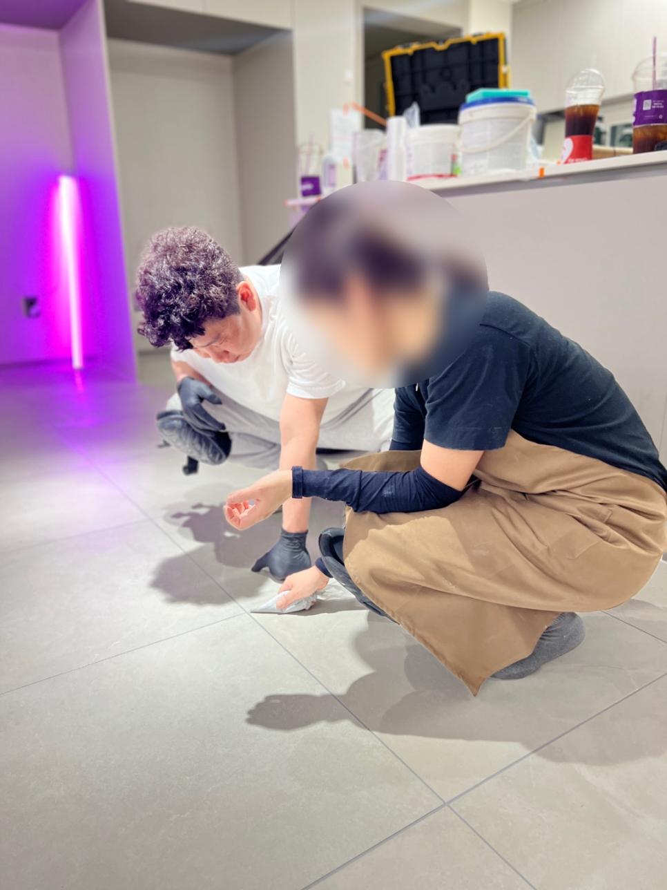 푸른 조명이 비치는 실내 바닥 타일 작업 공간