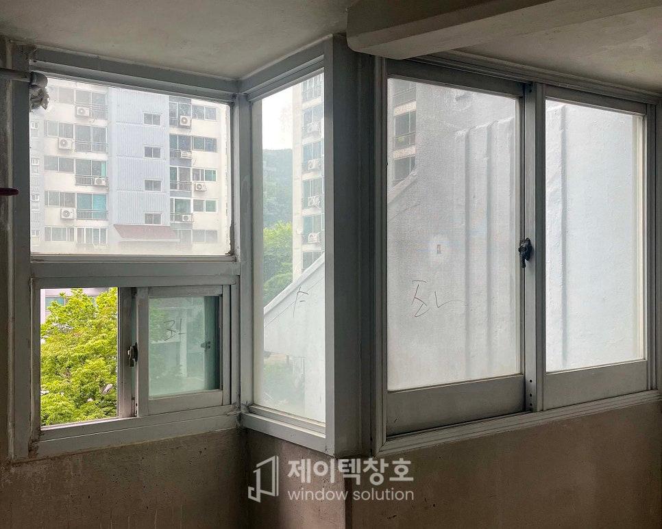 흰색 보호 필름이 붙은 유리와 회색 금속 창틀