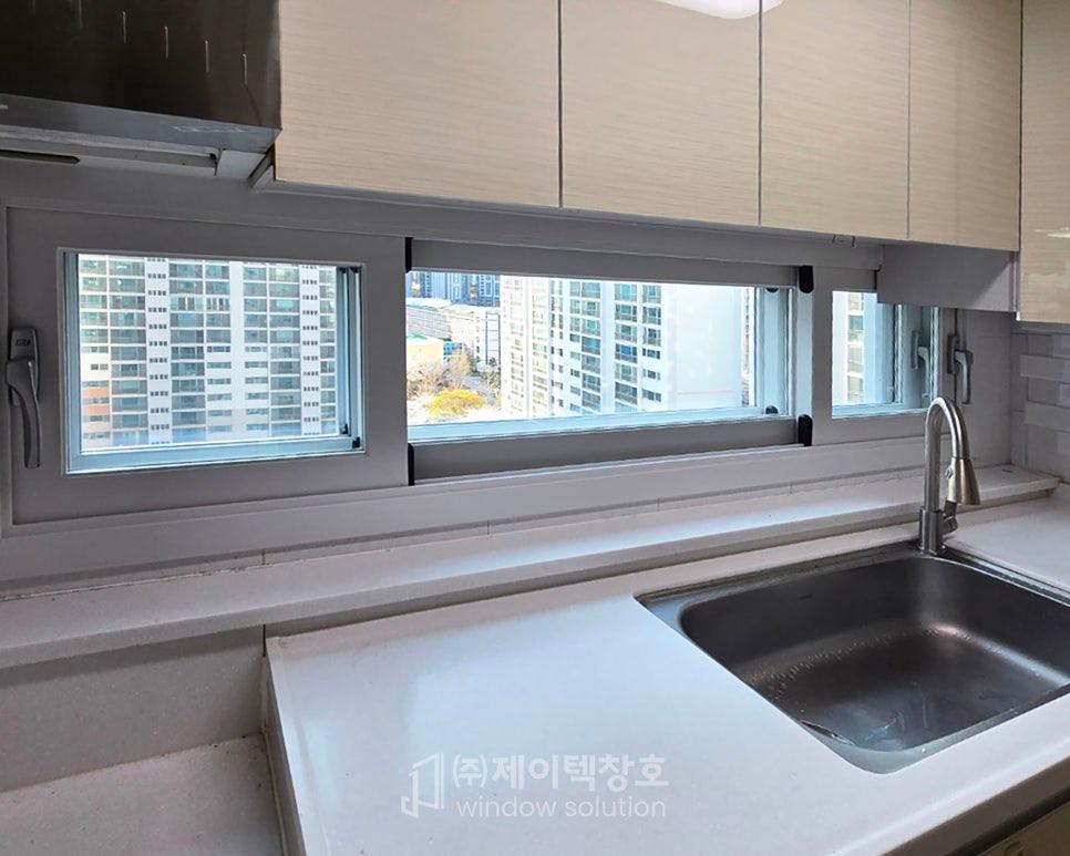 회색 창호와 스테인리스 싱크볼이 있는 주방