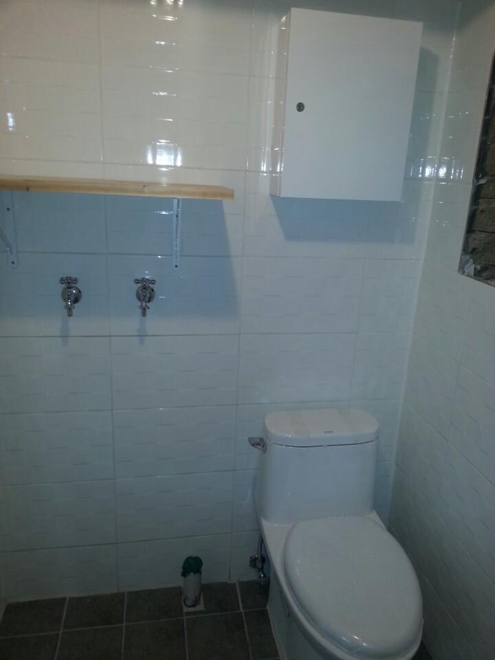 양변기와 줄눈 타일이 보이는 욕실 모습