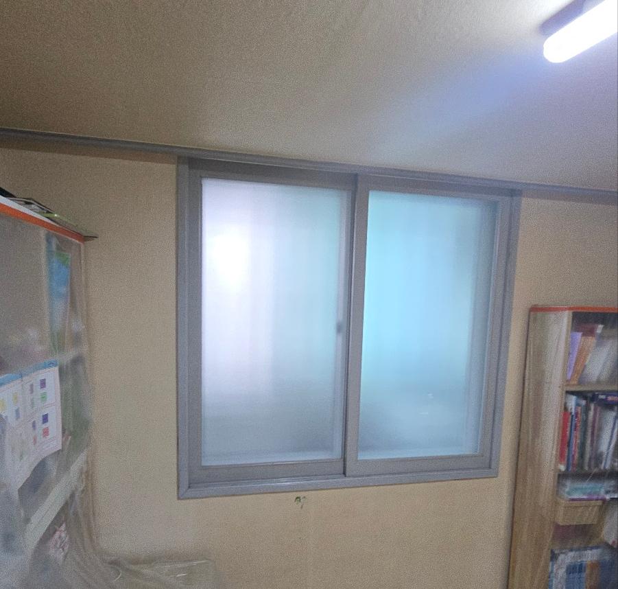 책장과 선반이 있는 서재 공간의 창호 교체 과정