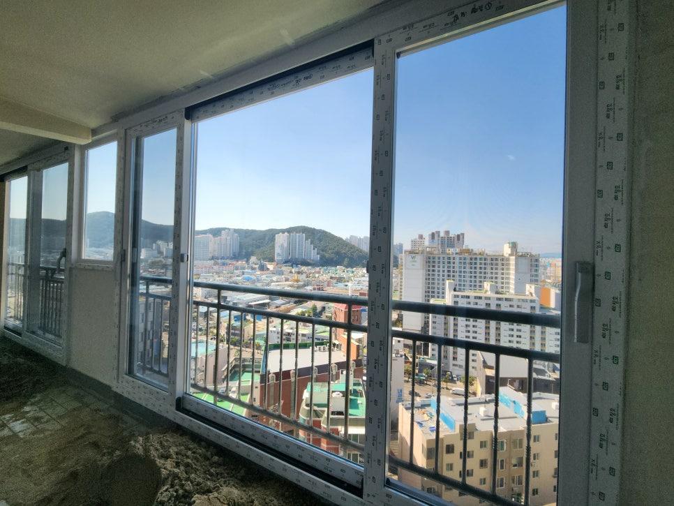 바닥면이 노출된 발코니 공간에 설치된 유리창호와 외부 전경