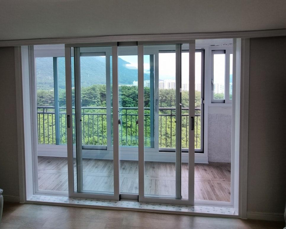슬라이딩 구조의 창호와 나무 패턴 바닥재가 보이는 모습