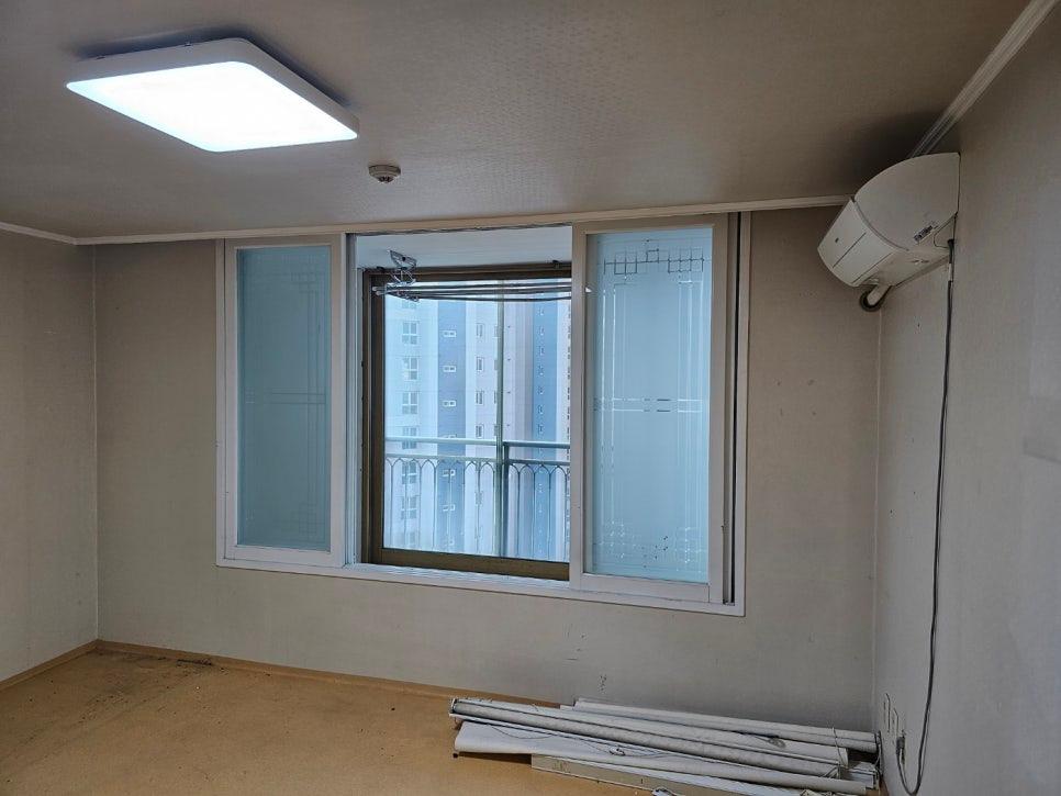 흰색 프레임 창문과 벽걸이 에어컨이 있는 실내