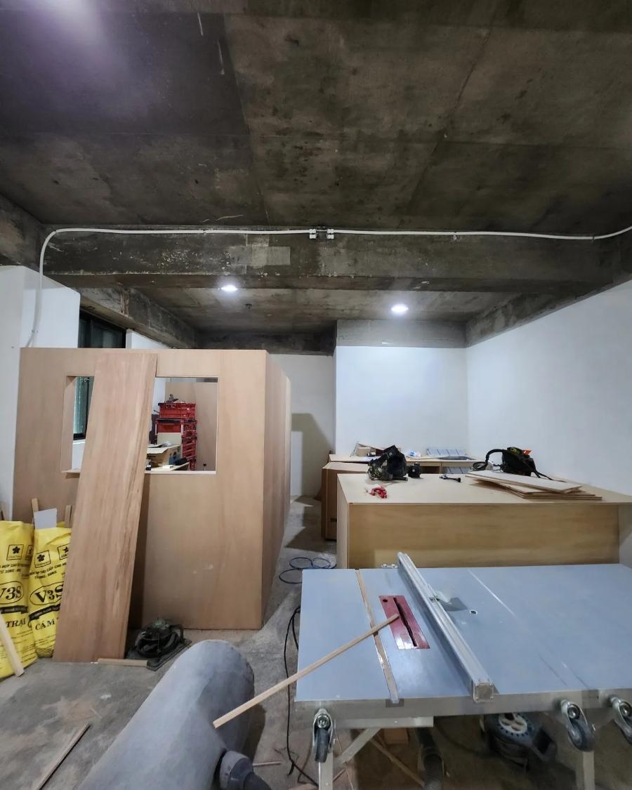 목재 가구와 공구가 놓인 작업 중인 실내