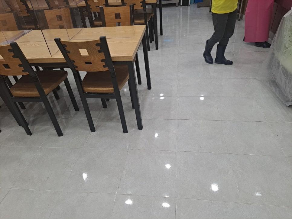밝은 타일 바닥과 나무 테이블이 배치된 공간