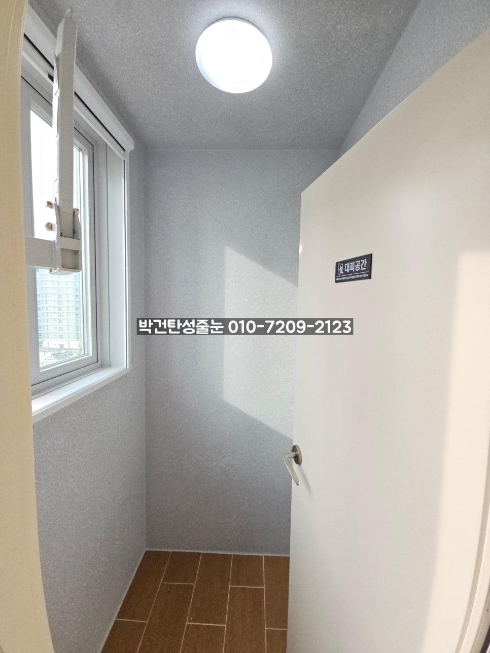 회색 벽면과 갈색 타일 바닥이 보이는 복도