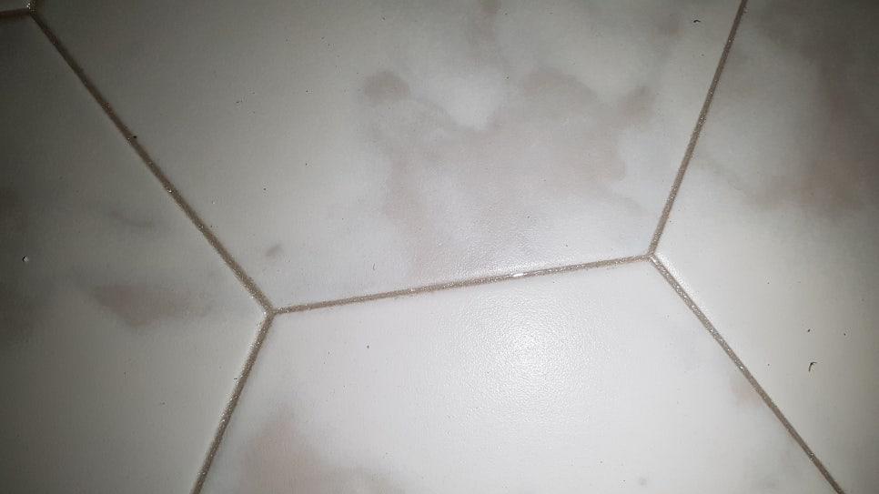 기초 제거 공정이 진행 중인 흰색 타일 바닥