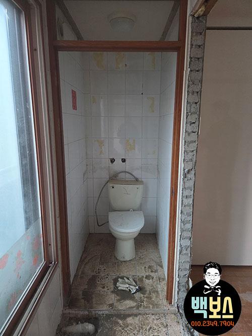 흰색 위생도기가 배치된 흰 타일 욕실