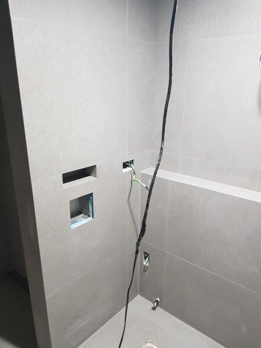 회색 타일 벽면에 노출된 전선