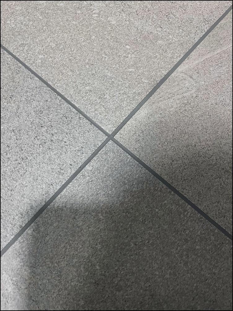회색 타일 바닥 표면의 검은색 틈새