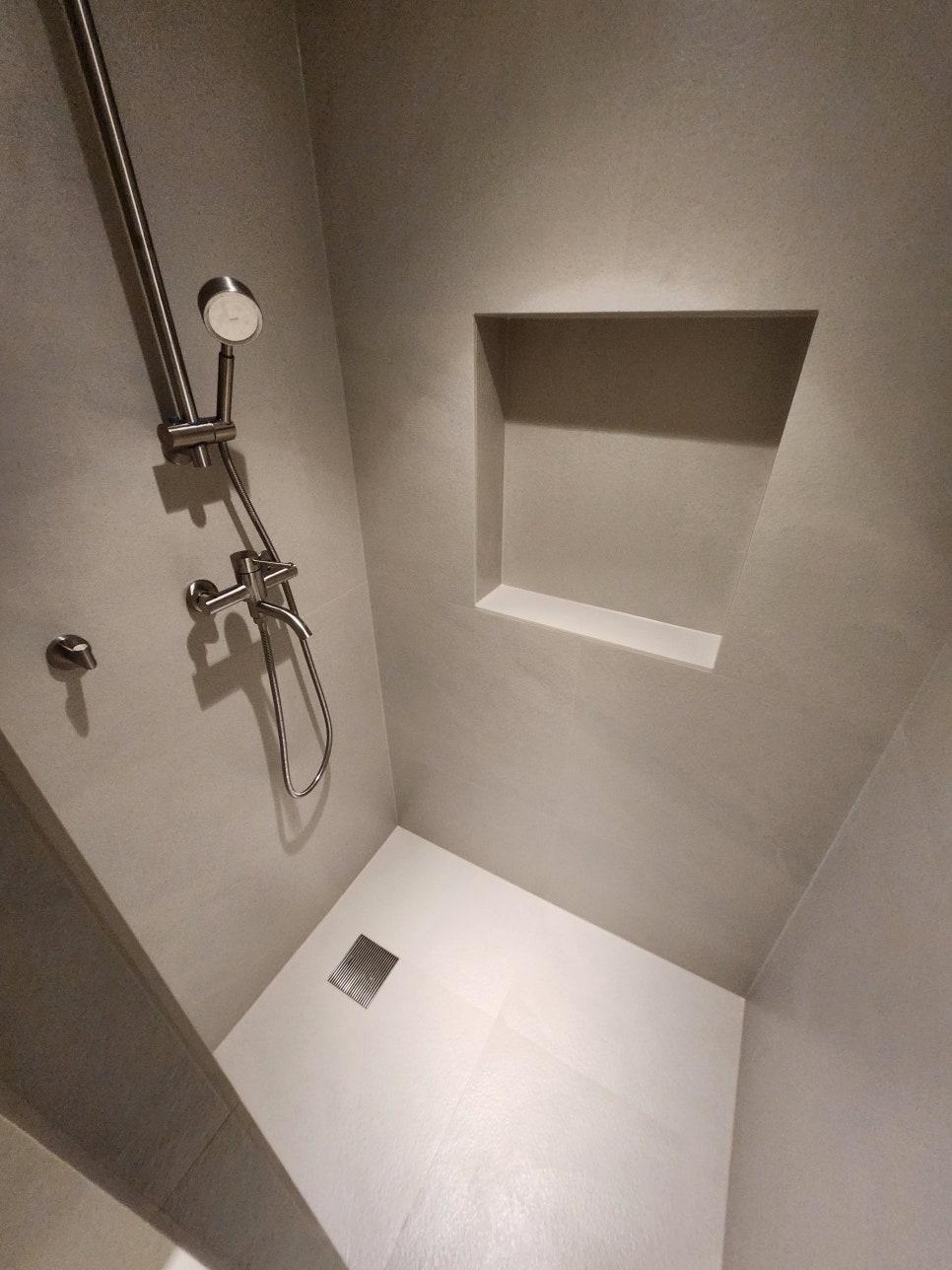차분한 회색 벽면과 흰색 바닥 타일의 조화