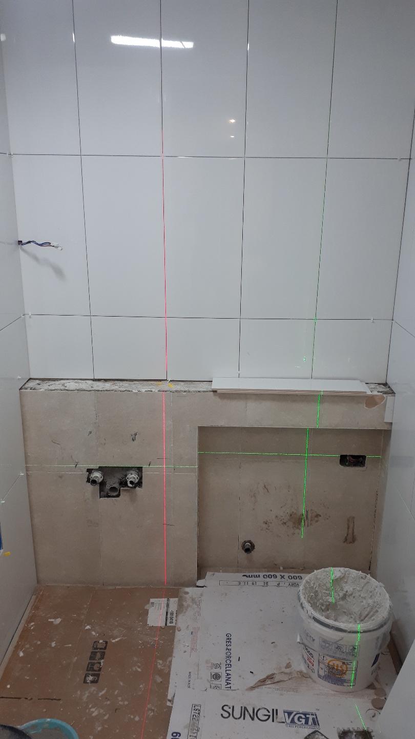 흰색과 베이지색 타일이 조합된 벽면과 가이드 라인