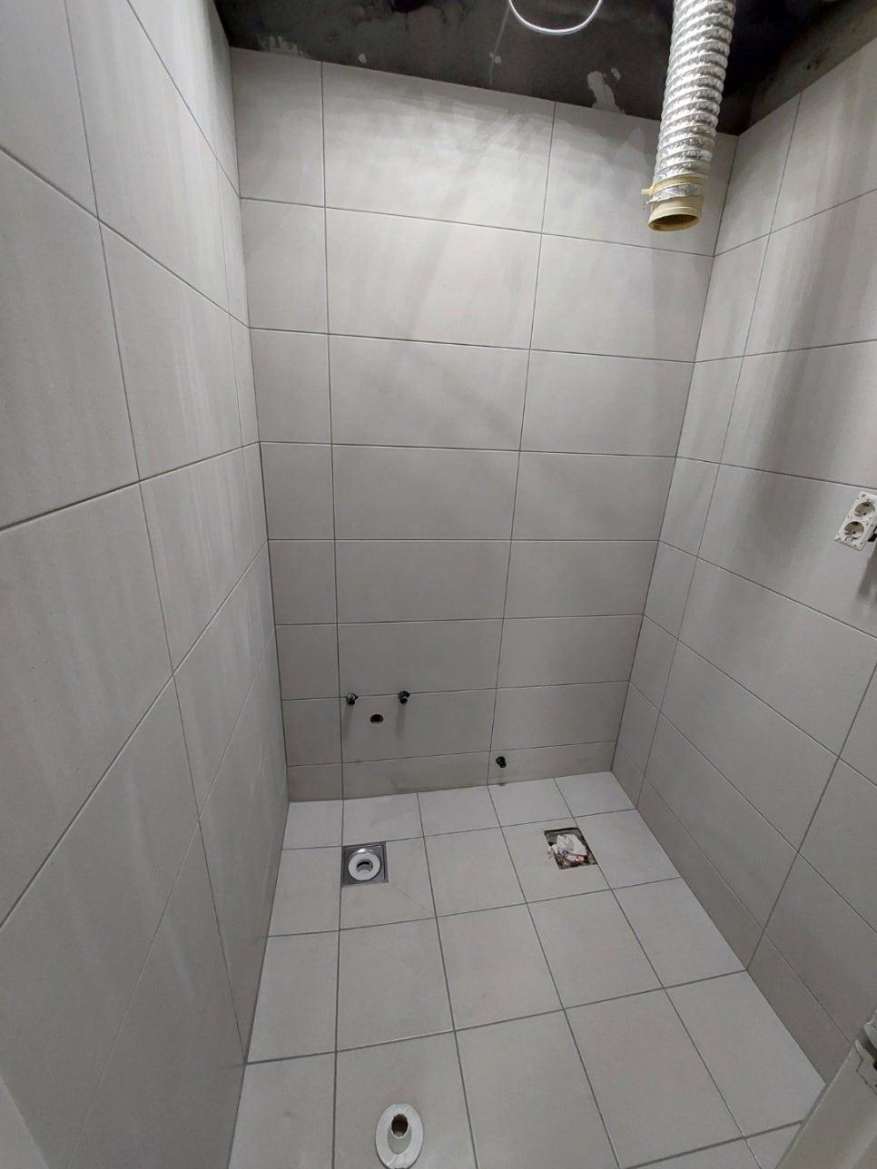 벽면 타일의 줄눈을 맞추며 부착하는 과정