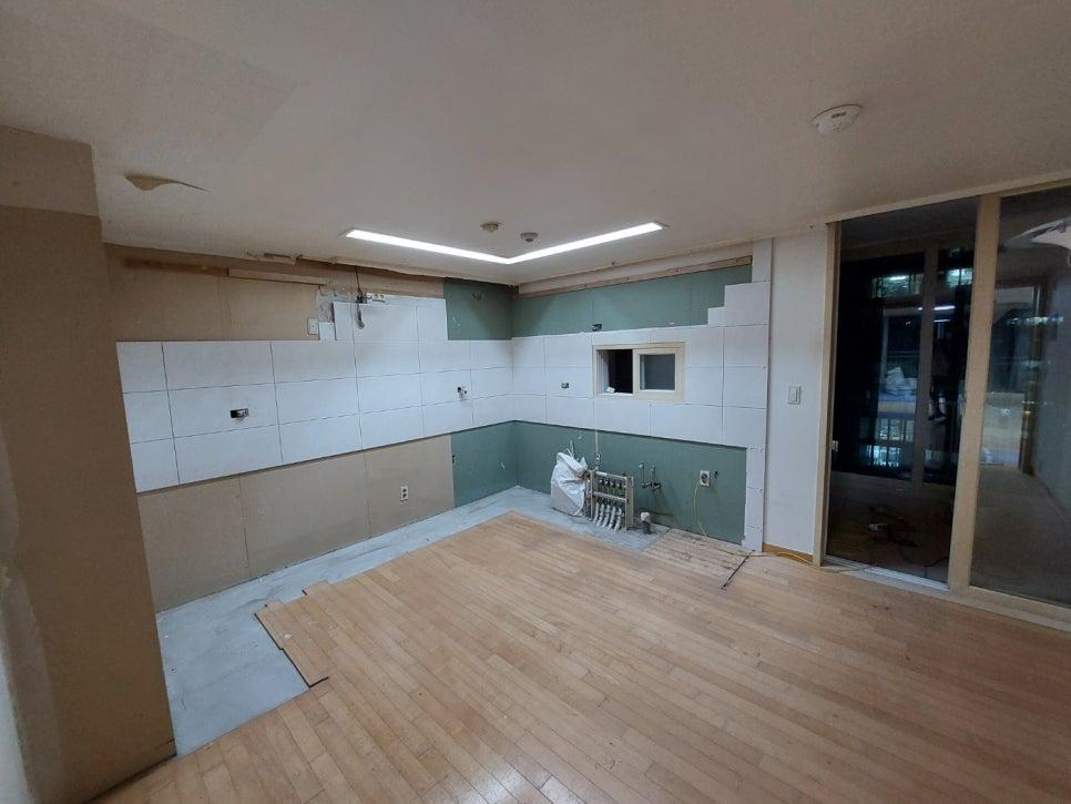 벽 타일과 마루가 설치 중인 실내 공간