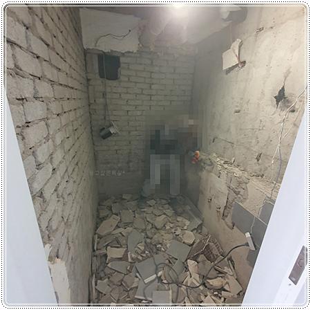 콘크리트 조각과 벽돌 잔해가 드러난 벽면