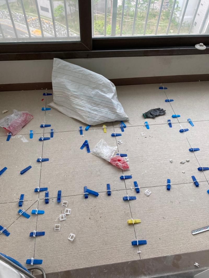 금속 측정기와 고정 클립을 이용한 타일 부착 과정