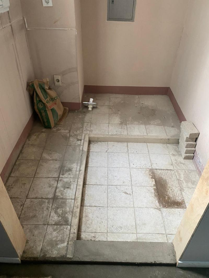 베이지색 벽면과 흰색 타일 바닥의 면 정리 상태