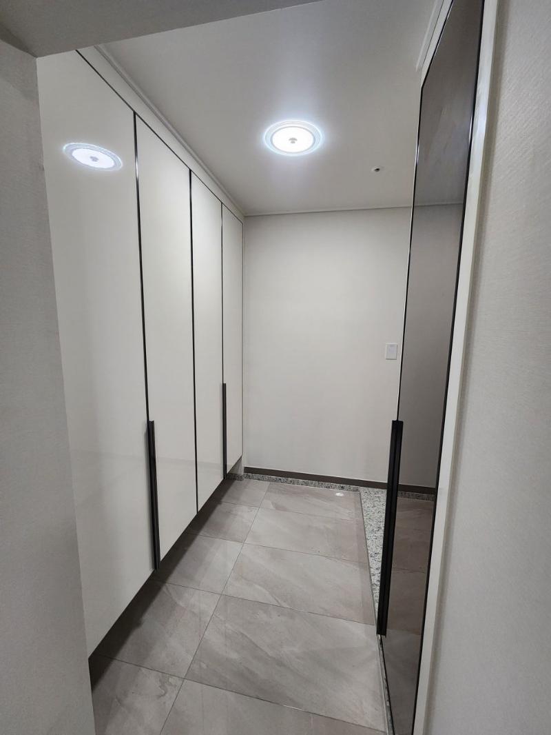 검은색 핸들이 포인트가 된 무광 화이트 복도 수납장