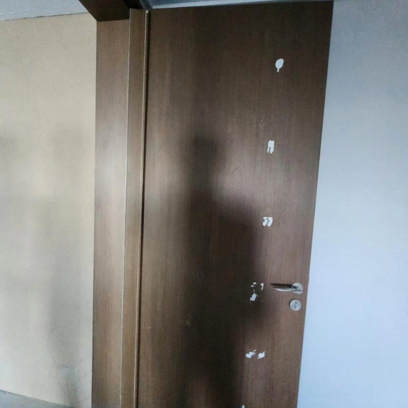흰색 흠집이 보이는 도어 표면과 설치된 손잡이