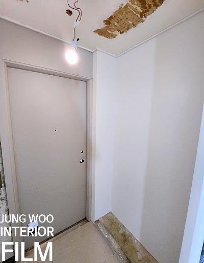 천장 손상 부위와 조명이 보이는 복도 공간의 작업 모습