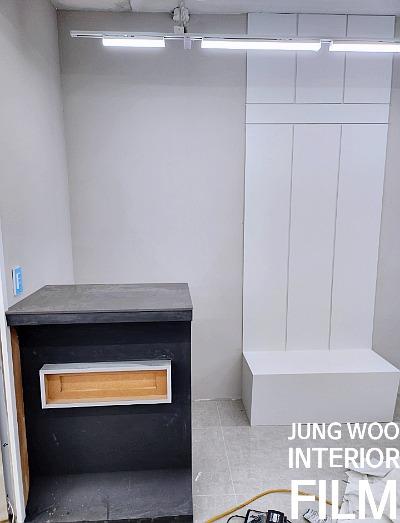 검은색 상판 가구와 흰색 수납장이 놓인 내부