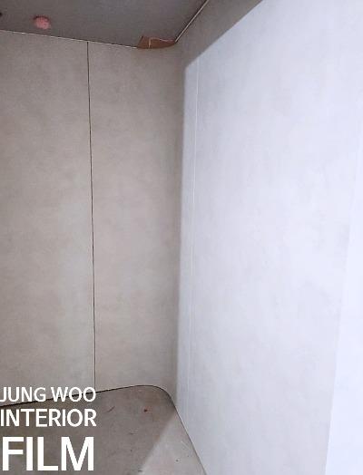 베이지색 벽면과 회색 바닥재가 보이는 공간