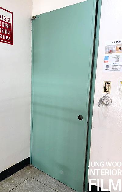 전기 소켓과 녹색 도어가 보이는 벽면 공간