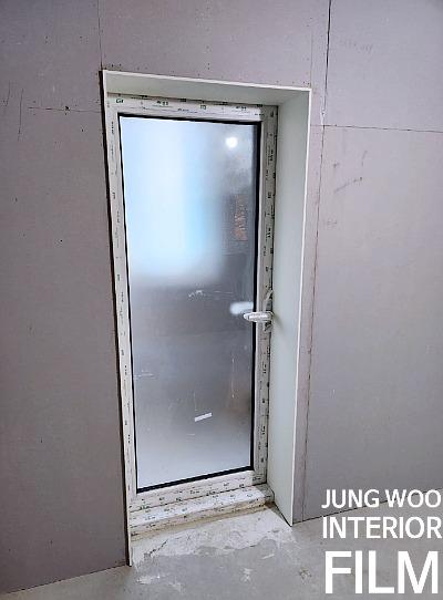 유리 패널과 힌지가 보이는 여닫이 도어