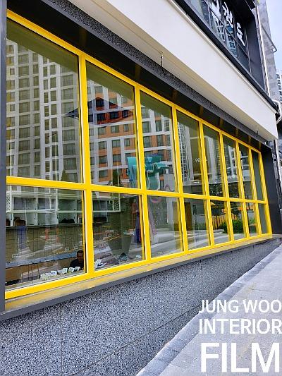 노란색 프레임이 돋보이는 실내 유리창