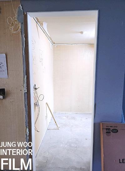 흰색 보드로 마감된 복도 벽면과 문틀
