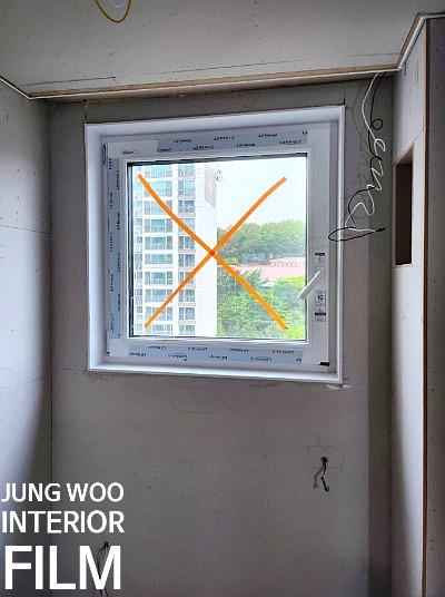 오렌지색 표시가 된 창호 유리와 미마감 벽면