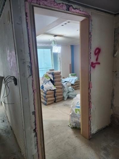 분홍색 마감재가 남은 문틀과 적재된 포장재