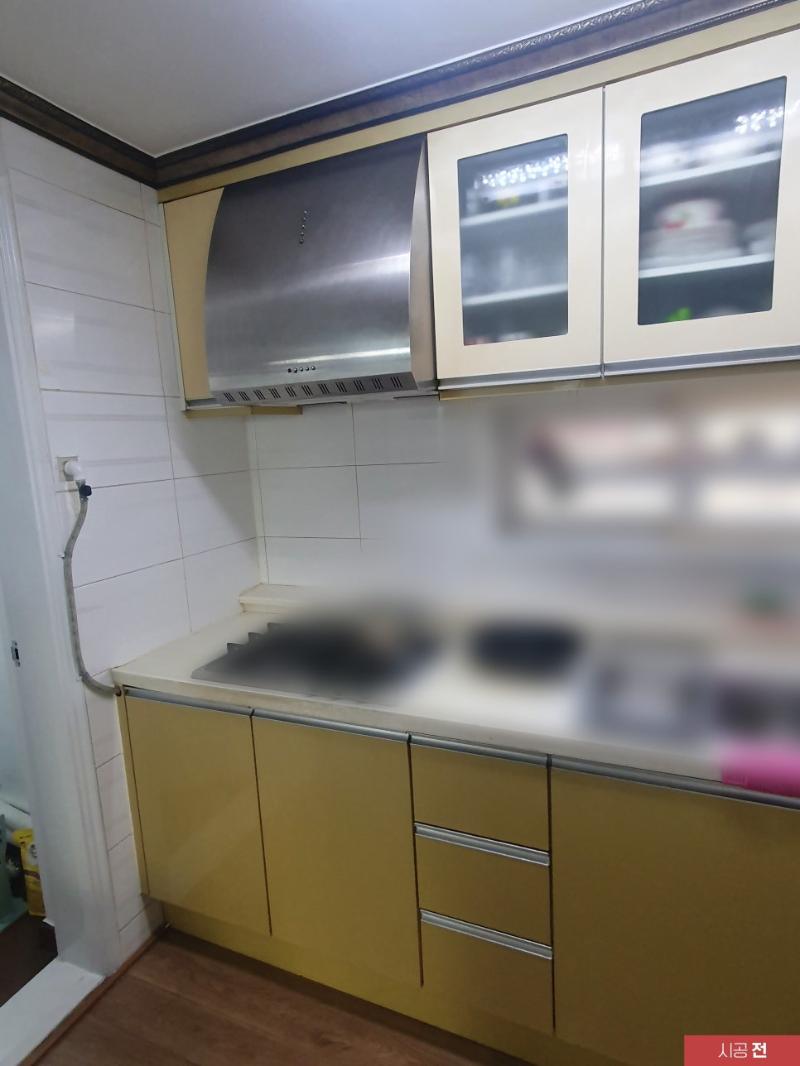 흰색 타일 벽면과 베이지색 수납장의 접점