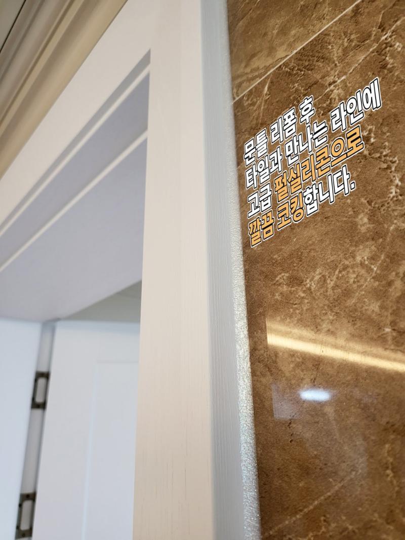 문틀과 타일 접합부에 진주펄 실리콘으로 코킹한 디테일