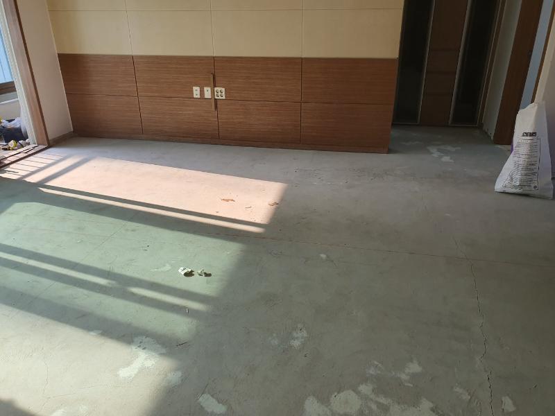 베이지색 타일 벽면과 회색 콘크리트 바닥
