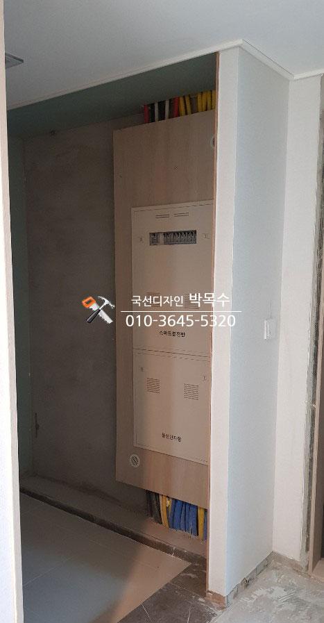 전기 박스와 전선이 노출된 현관 벽면
