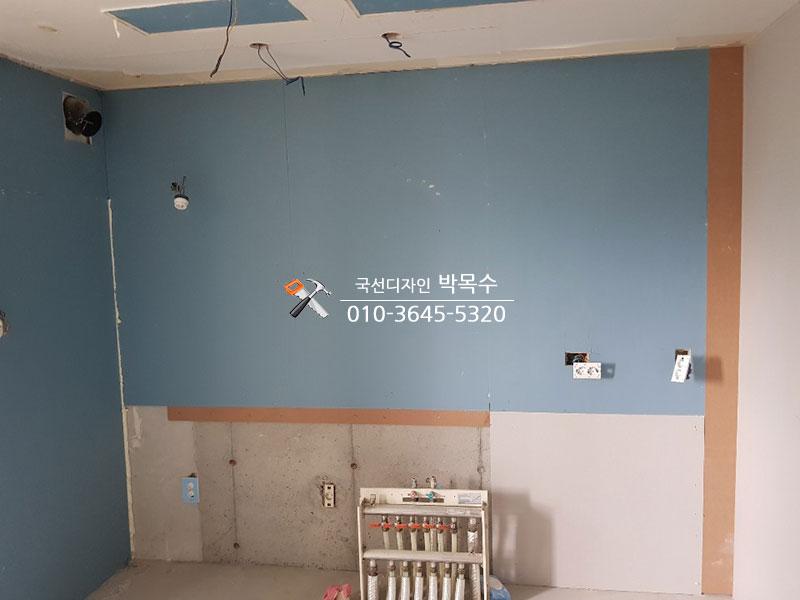 파란색과 흰색 보드로 마감된 벽면 상태