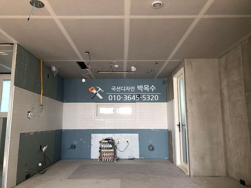 타일 벽면과 콘크리트 바닥이 보이는 시공 현장