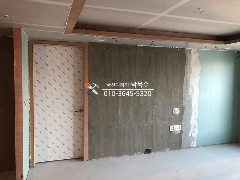콘크리트 벽면과 흰색 패턴 도배 문이 설치된 상태